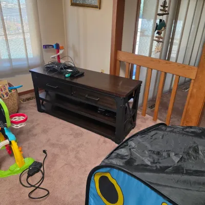 Sale Photo Thumbnail #17: Industrial-style dark wood and black metal media console featuring two drawers and open lower shelving, shown alongside various children's toys.