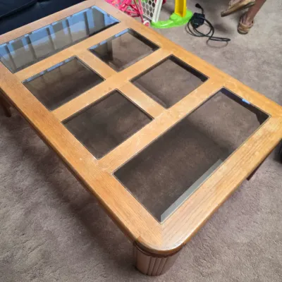 Sale Photo Thumbnail #30: Vintage oak coffee table featuring six inset smoked glass panels and rounded corners, showing some surface wear.
