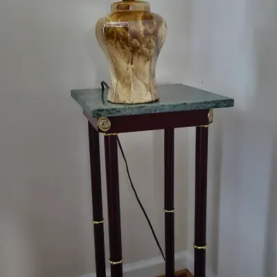 Sale Photo Thumbnail #7: Neoclassical style pedestal stand with a green marble top and mahogany-finished legs, supporting a vintage ceramic table lamp with a marbled glaze and pleated fabric shade.