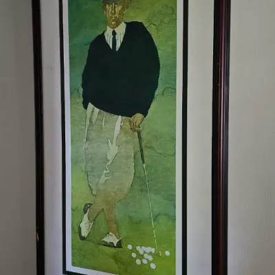 Sale Photo Thumbnail #17: Framed vintage-style art print depicting a golfer in classic attire leaning on a club, presented in a dark wood frame with a white mat.