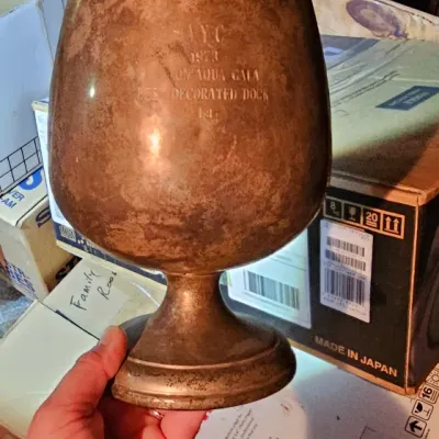 Sale Photo Thumbnail #21: Vintage tarnished metal trophy goblet, engraved with "A.Y.C. 1973 Aqua Gala Best Decorated Dock 1st."