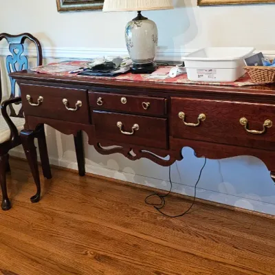 Sale Photo Thumbnail #10: Queen Anne style mahogany sideboard with brass hardware, accompanied by a set of matching dining chairs featuring upholstered seats and cabriole legs.