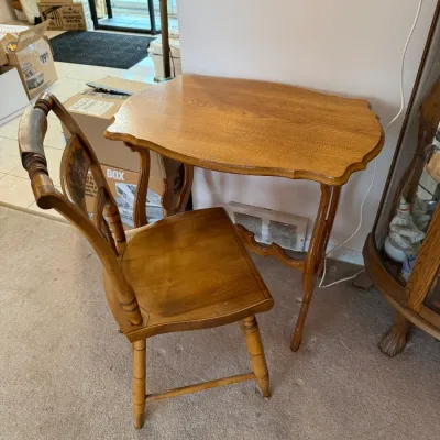 Sale Photo Thumbnail #13: Vintage oak writing desk with a scalloped edge top and a matching wooden side chair, showing light surface wear.