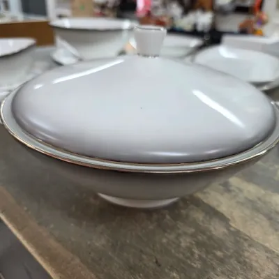 Sale Photo Thumbnail #34: Vintage white porcelain covered serving dish with silver trim, shown alongside other matching dinnerware pieces.