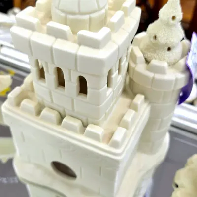 Sale Photo Thumbnail #79: Department 56 Snow Village "Sandcastle" ceramic accessory, featuring a detailed off-white castle structure with bottle brush trees.
