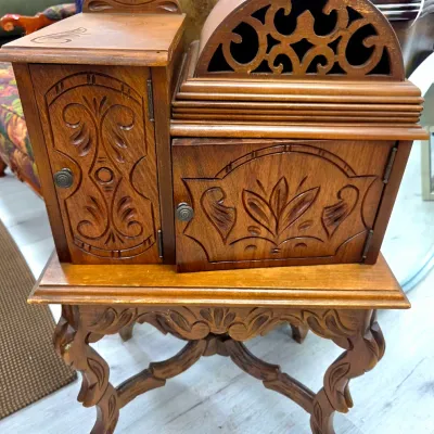 Sale Photo Thumbnail #22: Vintage carved wood telephone table and cabinet combo, featuring ornate floral and scrollwork carvings, cabriole legs, and a built-in directory compartment.