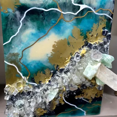 Sale Photo Thumbnail #12: Contemporary geode-style resin art piece featuring teal, gold, and white swirls, embellished with crushed glass and quartz crystal points.