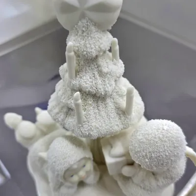 Sale Photo Thumbnail #84: Department 56 Snowbabies porcelain figurine featuring two snowbabies under a textured, candle-adorned Christmas tree topped with a star.