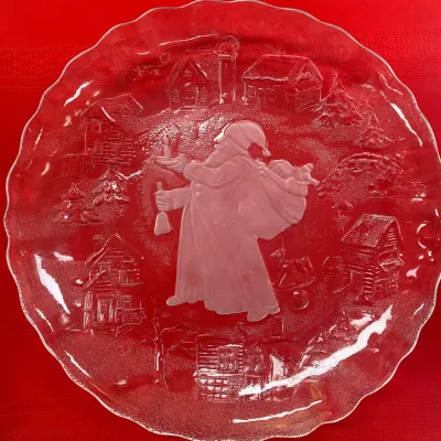 Sale Photo Thumbnail #51: Vintage clear pressed glass Christmas platter featuring a frosted central image of Santa Claus carrying a sack of toys, surrounded by a winter village scene.