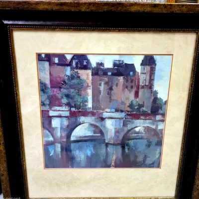 Sale Photo Thumbnail #20: Framed impressionistic art print depicting a European bridge and cityscape, presented in a wide, ornate dark wood and gold-toned frame with a cream mat.