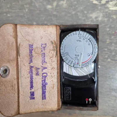 Sale Photo Thumbnail #39: Vintage German-made Gossen Sixtry light meter housed in its original leather case with a stamped doctor's name on the interior flap.