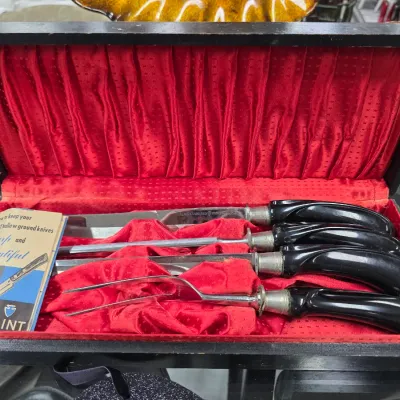 Sale Photo Thumbnail #45: Vintage Ekco Flint carving set with black handles, presented in its original red satin-lined wooden case with instructional booklet.