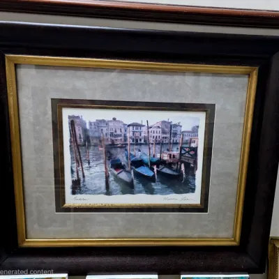 Sale Photo Thumbnail #16: Framed and matted print titled "Gondolas" by Maureen Love, depicting Venetian gondolas moored along a canal, housed in a dark wood frame with gold-toned inner trim.