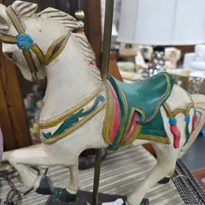 Sale Photo Thumbnail #26: Vintage painted wooden carousel horse figurine on a brass pole and decorative base, featuring a green saddle and colorful harness details.