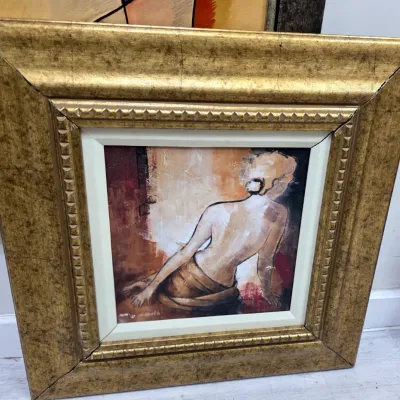Sale Photo Thumbnail #19: Framed oil painting depicting a seated female figure from behind, set in a wide, ornate gold-finished wooden frame with a white inner liner.