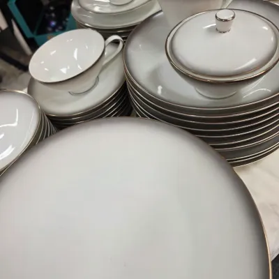 Sale Photo Thumbnail #35: Noritake fine china dinnerware set in the 'Platinum Wave' or similar pattern, featuring a white center with a grey gradient rim and platinum trim, including plates, teacups, saucers, and a lidded sugar bowl.