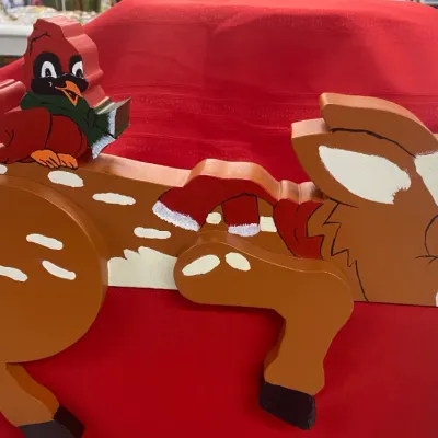 Sale Photo Thumbnail #54: Hand-painted wooden Christmas shelf sitter featuring a sleeping fawn with a cardinal perched on its back.