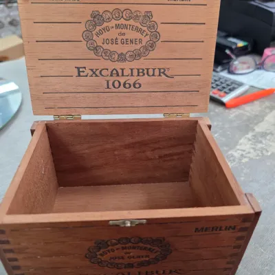 Sale Photo Thumbnail #41: Empty Hoyo de Monterrey Excalibur 1066 Merlin wooden cigar box with a hinged lid, showing some light wear.