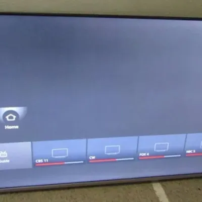 Sale Photo Thumbnail #4: Modern flat-screen smart television shown powered on, displaying a home menu interface.