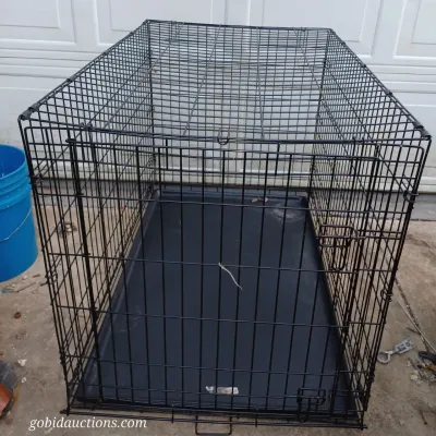 Sale Photo Thumbnail #39: Large black wire dog crate with a removable plastic bottom tray, showing some light wear.
