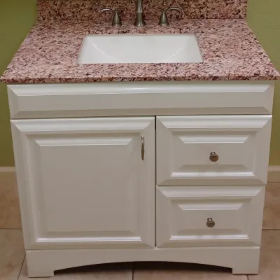Sale Photo Thumbnail #30: Modern white bathroom vanity featuring a pink and brown granite countertop, undermount sink, and brushed nickel faucet hardware.