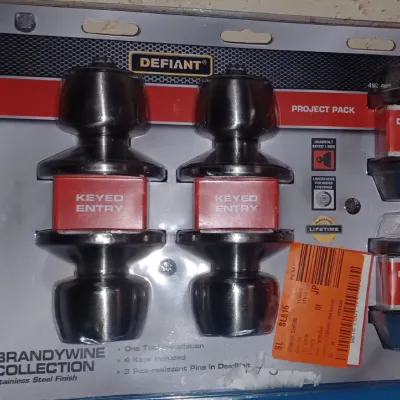 Sale Photo Thumbnail #28: Defiant Brandywine Collection project pack in stainless steel finish, featuring two keyed entry doorknobs and two single-sided deadbolts in original retail packaging.