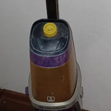 Sale Photo Thumbnail #25: Bissell ProHeat 2X Revolution Pet Pro carpet cleaner, featuring a purple and silver body with dual water tanks.
