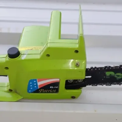 Sale Photo Thumbnail #22: Poulan Patriot EL-14 electric chainsaw featuring a lime green housing and a short power cord tail.