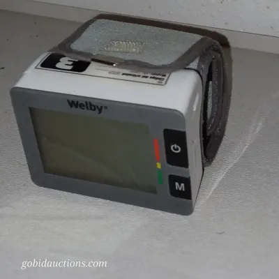 Sale Photo Thumbnail #23: Welby digital wrist blood pressure monitor with adjustable grey cuff, showing minor wear.