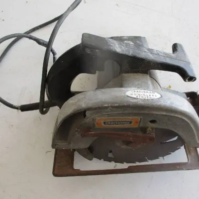 Sale Photo Thumbnail #8: Vintage Craftsman circular saw with a non-glare finish, showing signs of wear and age-related rust on the base and blade.