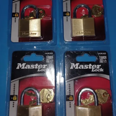 Sale Photo Thumbnail #21: Four new-in-package Master Lock 140KAD brass padlocks, each with two keys.