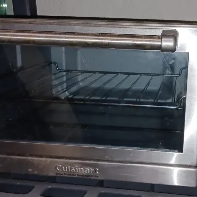 Sale Photo Thumbnail #18: Cuisinart Deluxe Convection Toaster Oven Broiler in stainless steel, showing some signs of use and wear.