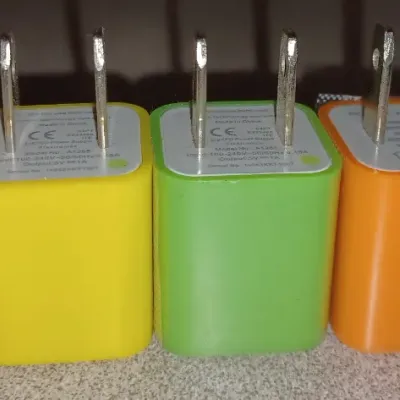 Sale Photo Thumbnail #50: Set of five colorful USB wall charger adapters in pink, yellow, green, orange, and blue.