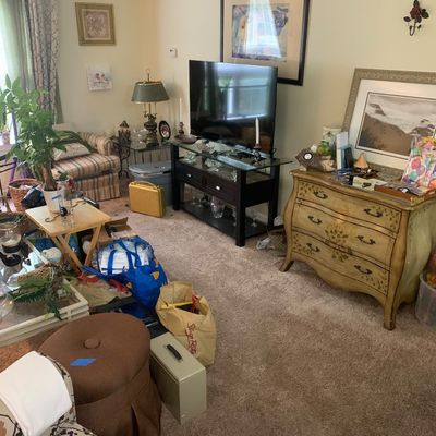 Sale Photo Thumbnail #17: Living room filled with various items for sale, including a flat-screen TV on a black stand, a hand-painted French provincial style chest of drawers, framed wall art, and assorted home decor.