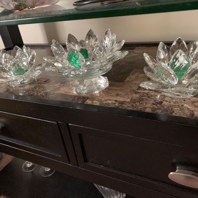 Sale Photo Thumbnail #13: Three faceted crystal lotus flower candle holders, including one elevated on a pedestal, featuring green accents in the center.