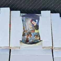 Three Disney Snow White and the Seven Dwarfs collector plates, housed in their original cardboard packaging with certificates of...