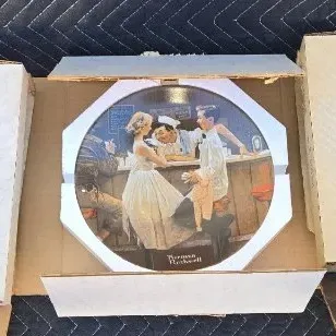 Three vintage Norman Rockwell collector plates, including "The Runaway" and "The Ship Builder," in their original...