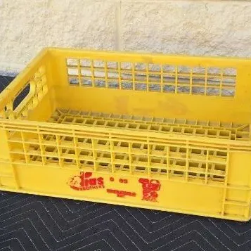 Vintage yellow plastic Elias Brothers Big Boy milk crate with red printed graphics, showing some wear from age and use.