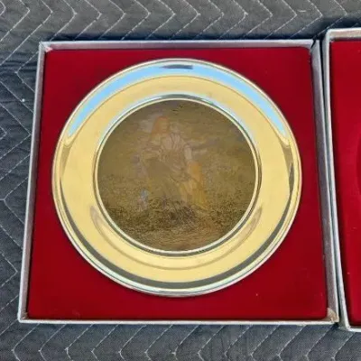 Vintage sterling silver and gold-plated collector plate featuring an etched classical scene, presented in its original red velvet-lined...