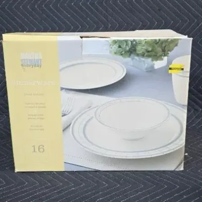 Martha Stewart Everyday 16-piece dinnerware set in its original box, featuring a simple white design with blue borders.