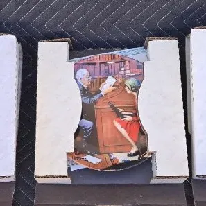 Three Norman Rockwell collector plates in their original styrofoam packaging, depicting various nostalgic scenes.
