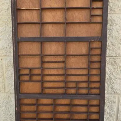 Vintage wooden printer's type drawer with numerous small compartments, suitable for use as a shadow box display.