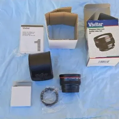 Vivitar 2X Telephoto Video Lens with original box, leather case, manual, and accessories.