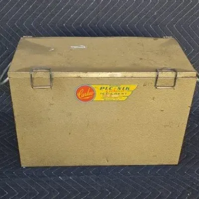 Vintage Carlco Pic-Nik metal ice chest in a textured gold finish, featuring original decals and metal latches.