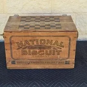 Vintage National Biscuit Company wooden crate with a hinged lid featuring a painted checkerboard pattern.