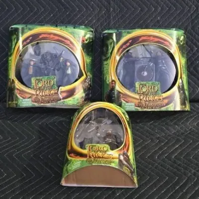 Three Toy Biz Lord of the Rings: The Fellowship of the Ring action figure sets in their original packaging, circa 2001.