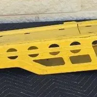 Vintage yellow Tonka pressed steel car carrier trailer, showing some wear and paint loss consistent with age.