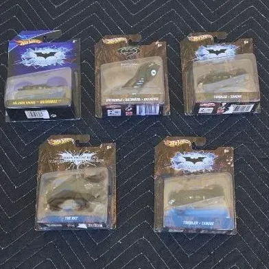 Collection of five Hot Wheels Batman-themed die-cast vehicles in their original blister packaging, including models of the Batmobile,...