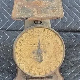 Antique Columbia Family Scale by Landers, Frary & Clark, featuring a heavily weathered metal body, rusted top platform, and a...