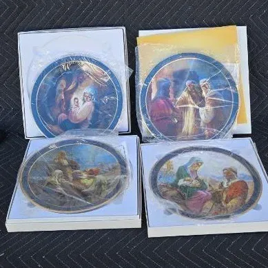 Set of four vintage religious collector plates depicting biblical scenes, each in its original box and protective plastic wrapping.